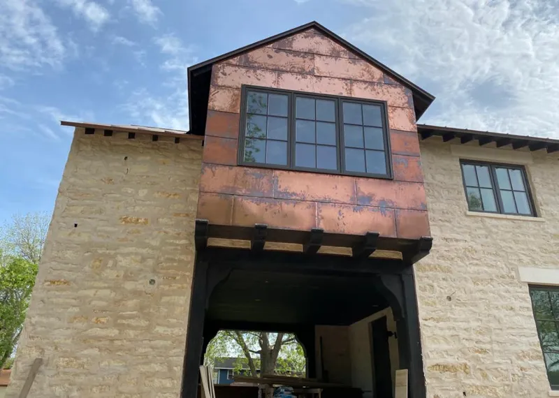 Copper metal panel facade on a stone building for Skylight Installation in Chamblee