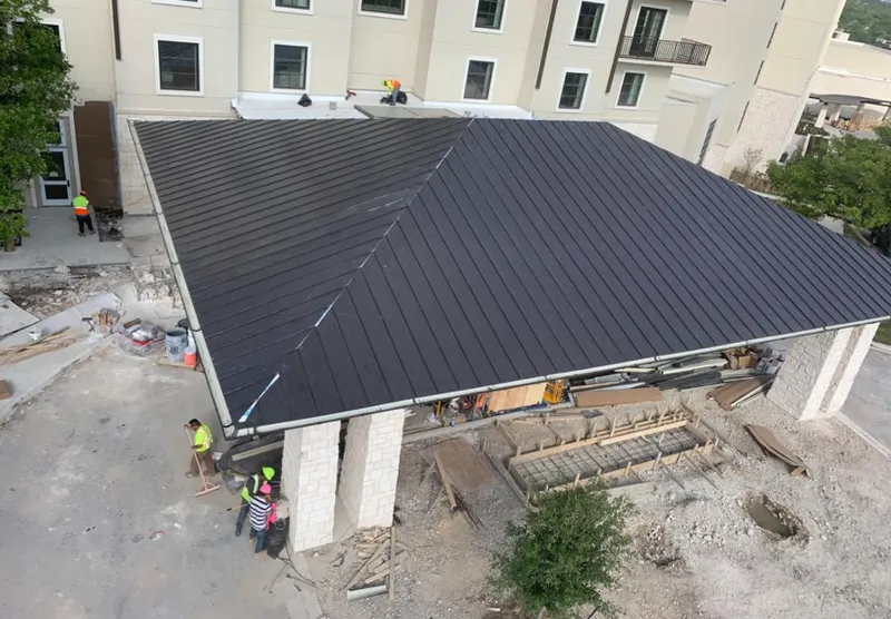 Metal roofing installation team working on a commercial building in Chamblee