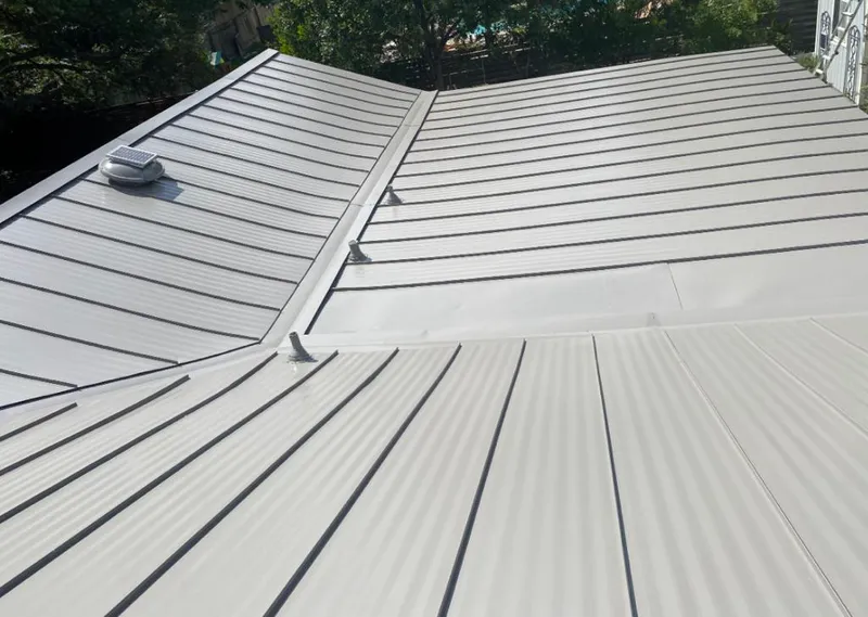 Solar attic fan installed on a metal roof for Roof Ventilation in Chamblee